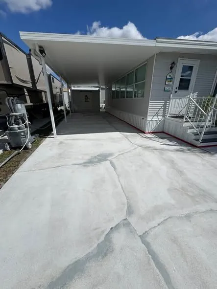 Before: a cracked carport slab repaired and resurfaced.
