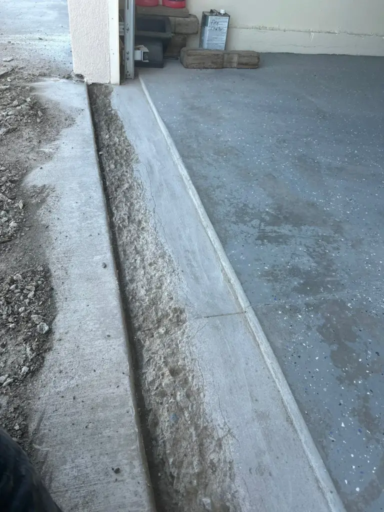 Garage threshold with a crumbling concrete edge