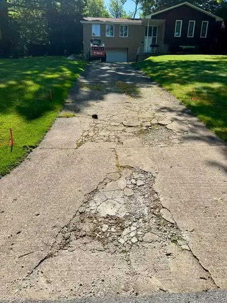 Before: a broken, crumbling driveway replaced with new concrete.