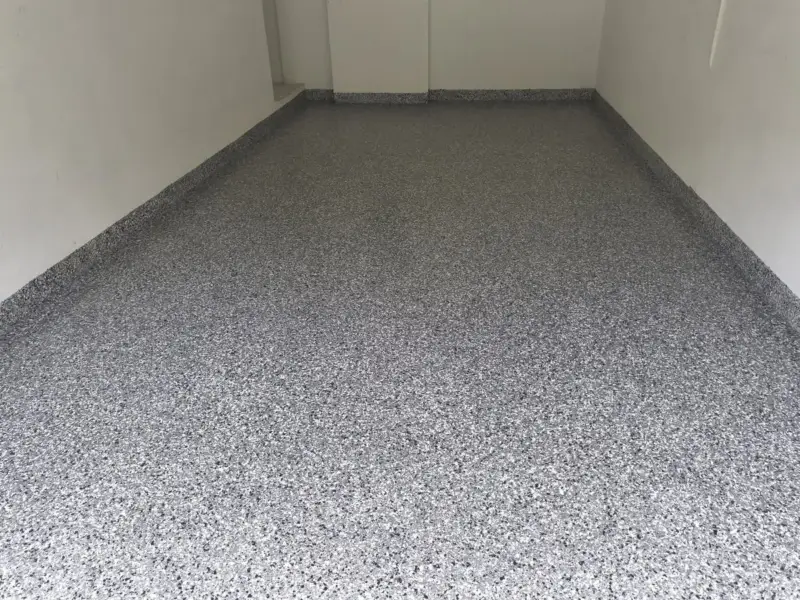 After: cracks filled first, then a full flake coating over the whole floor.