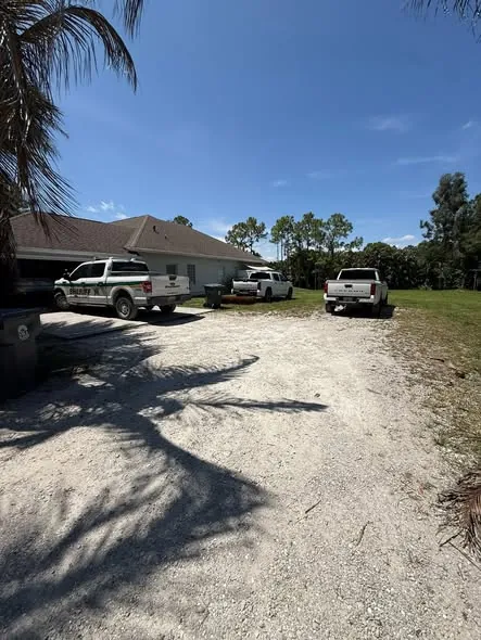 Worn gravel driveway in front of a Florida home before concrete work