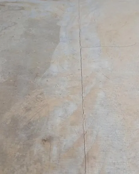 Close-up of a long crack running across a concrete slab