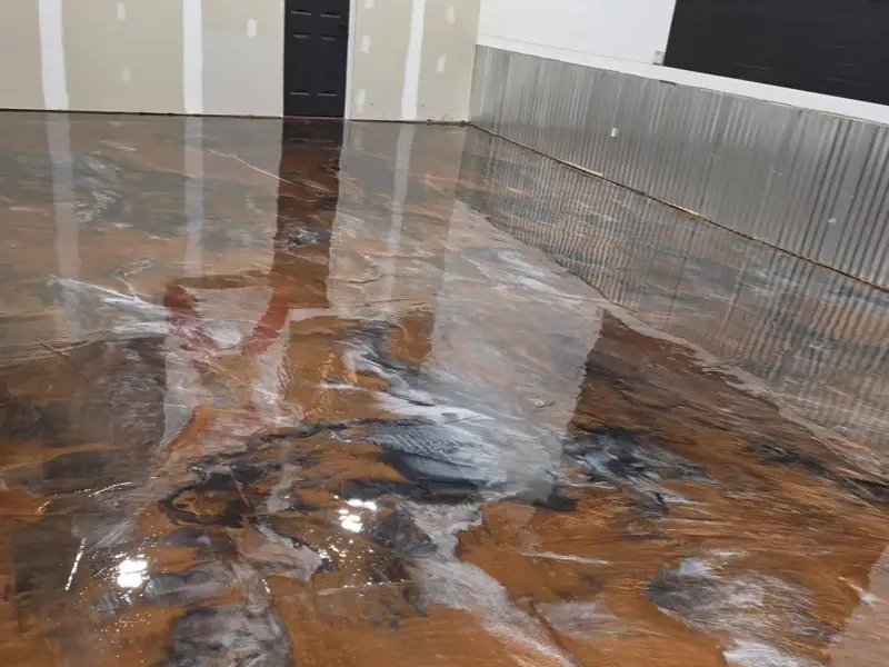 After: a bare slab finished with a metallic epoxy floor.