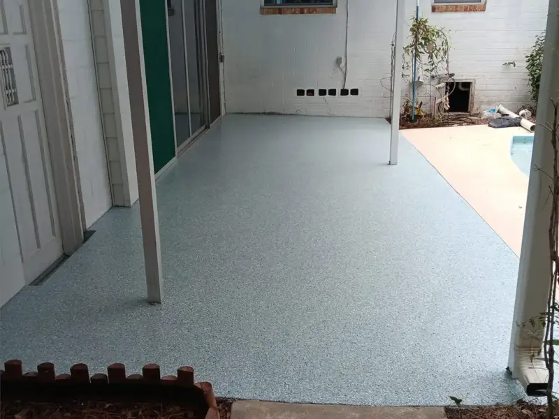After: a stained, worn patio slab resurfaced with a new finish.