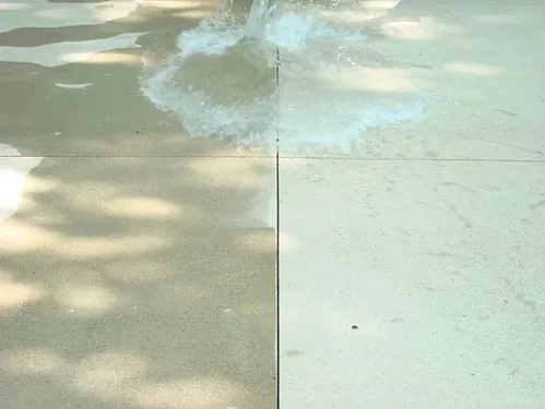 Water soaking into unsealed concrete on one side of a joint and sitting on sealed concrete on the other
