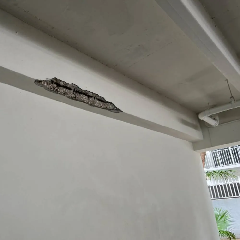 Concrete beam with a chunk broken away and rebar showing