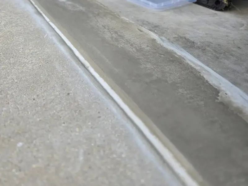 After: flaking, pitted concrete at a threshold cut out and patched smooth.
