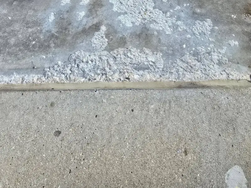 Before: flaking, pitted concrete at a threshold cut out and patched smooth.