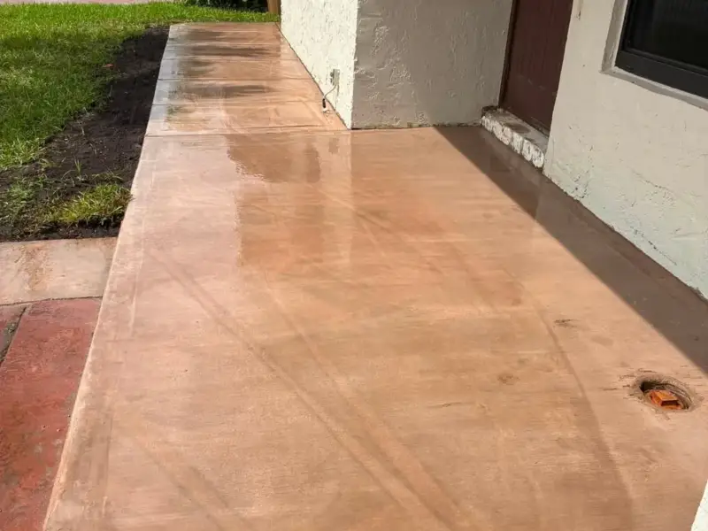 Entry patio with a glossy stained and sealed concrete surface